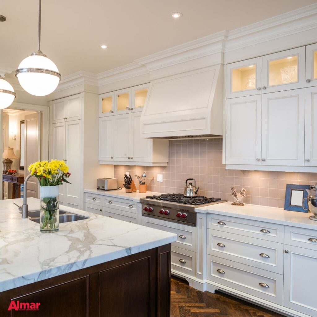 Kitchen remodel with white cabinets, tile backsplash and matching hood vent