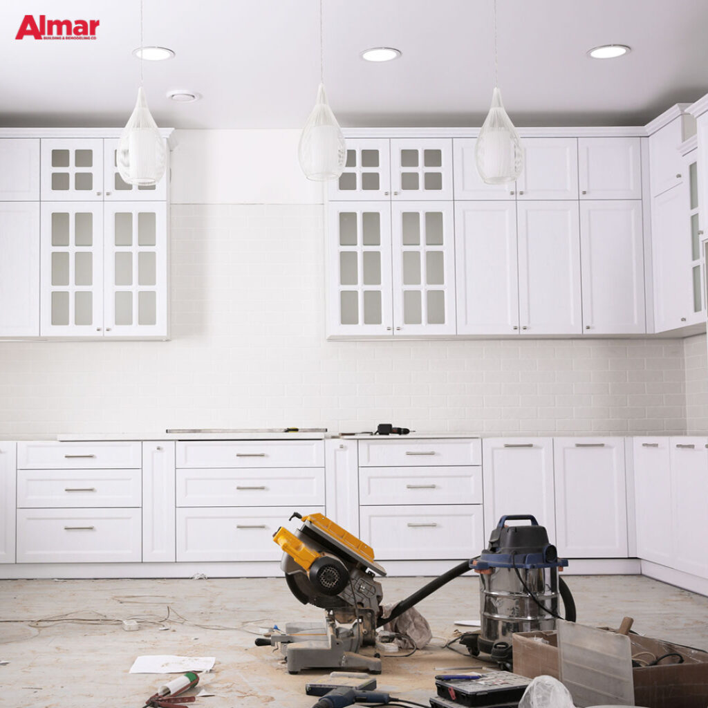 White kitchen cabinets being installed