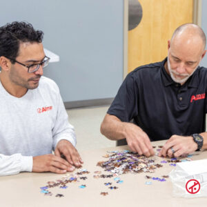 Project Manager and Estimator working on a puzzle