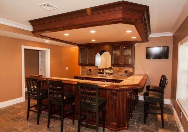 Custom pub bar in basement with oak drink rail top and recessed lighting. Hanover Ma, Almar Building and Remodeling