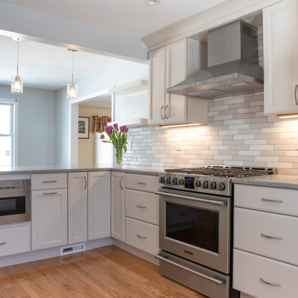 Bright kitchen remodel with white cabinets and hardwood flooring